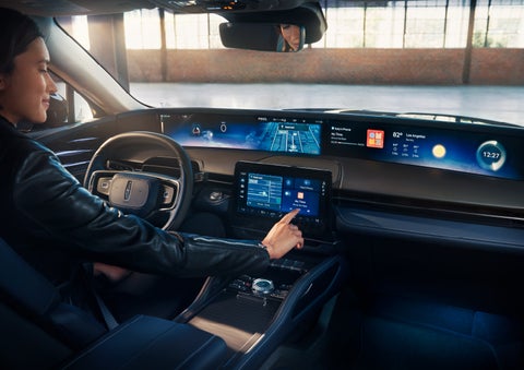 The driver of a 2024 Lincoln Nautilus® SUV interacts with the center touchscreen. | Parks Lincoln of Tampa in Tampa FL